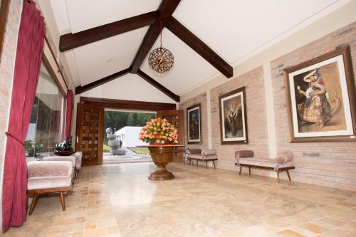 a living room with a brick wall at Hotel Medina Del Lago in Otavalo