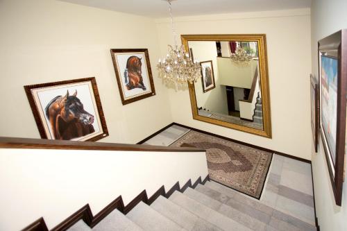 a hallway with pictures of a horse on the wall at Hotel Medina Del Lago in Otavalo