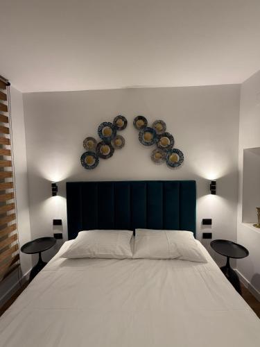 a bedroom with a bed with three plates on the wall at RotHaus Old Town Sibiu in Sibiu
