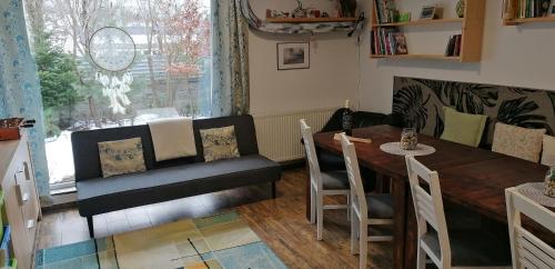 a dining room with a table and chairs and a window at Qvintesencia Terchová in Terchová