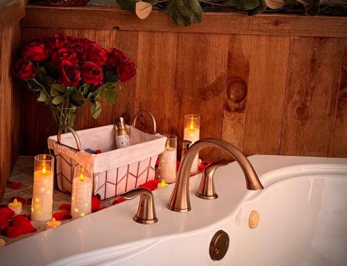 a bathroom sink with candles and a basket of roses at Romantic A-frame HeartJacuzzi Firepit Kayaks in Warsaw