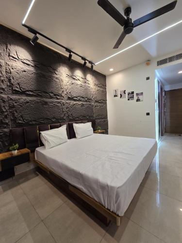 a bedroom with a large bed and a black wall at Omex hazratganj arjunganj in Nalmatha