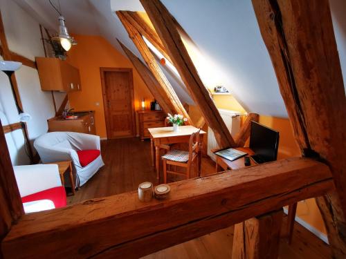an attic room with a bedroom and a desk with a laptop at Haus Seenland in Feldberg