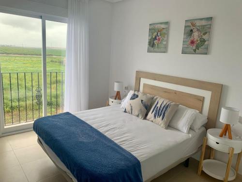 a bedroom with a bed and a large window at Casa Teuwisse in Torre-Pacheco