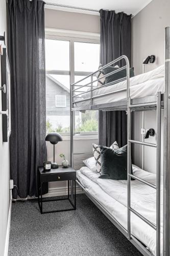 a bedroom with two bunk beds and a table at Tyringe Kurhotell in Tyringe
