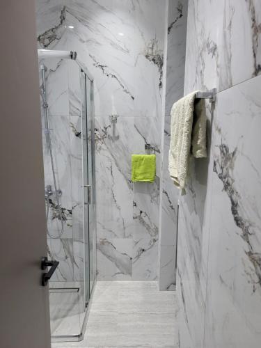 a shower with a glass door in a bathroom at Chryso Apts Protaras in Protaras
