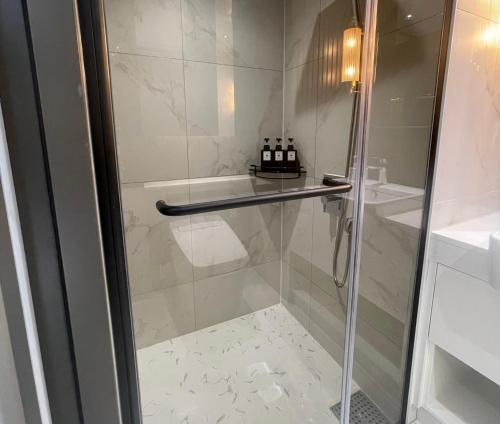a shower with a glass door in a bathroom at 서초 아트하우스2 in Seoul