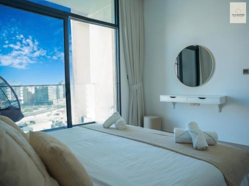 a bedroom with a bed with a large window at Elegant Haven by Meraki - New 1 Bed Garden View in Dubai