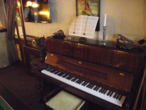 a piano sitting on top of a wooden table at The Molly House in Blackpool