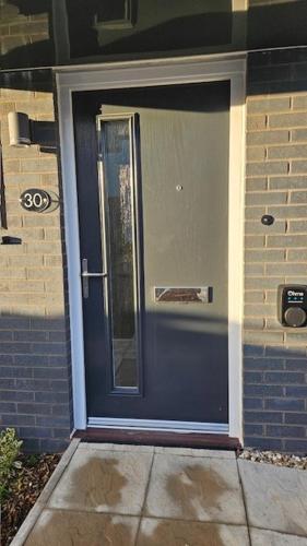 a blue front door of a house with at Eco House by Science Park, Airport and City Centre in Exeter