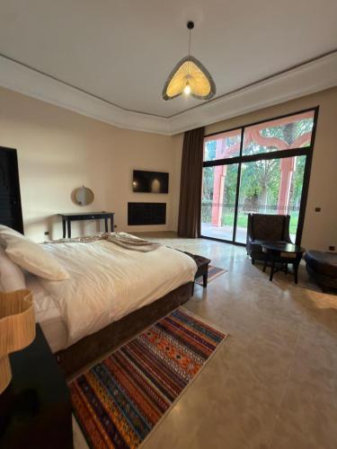 a bedroom with a large bed and a living room at Royal Moroccan House in Marrakesh