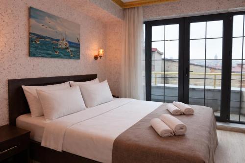 a bedroom with a large bed with two towels on it at Golden Horn Life Hotel- FULL BOARD in Istanbul