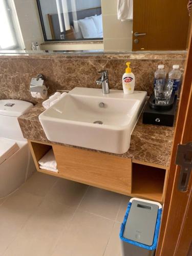 a bathroom with a white sink and a mirror at Wyndham garden villa 304 in Cam Lâm