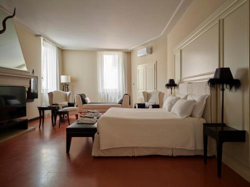 a bedroom with a large bed and a living room at Santa Maria Foris in Ravenna