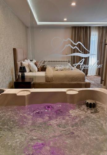 a bedroom with a bed and a pool of water at Guest House Panorama Aqualux with Free Parking in Novi Sad
