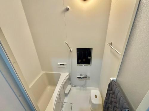 a small bathroom with a toilet and a sink at HOTTOSTAYKiyosu in Nagoya