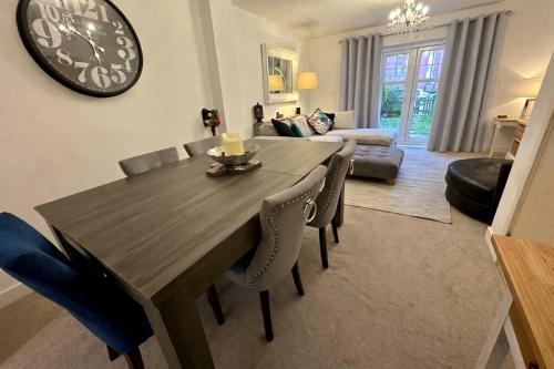 a dining room table and chairs in a living room at 4BR Cheshire East/Townhouse/Central - Close to Bentley in Crewe