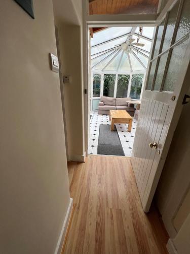a hallway with a living room with a glass ceiling at Ashley House Contemporary 4 Bedroom Stay for 13 in Inverness