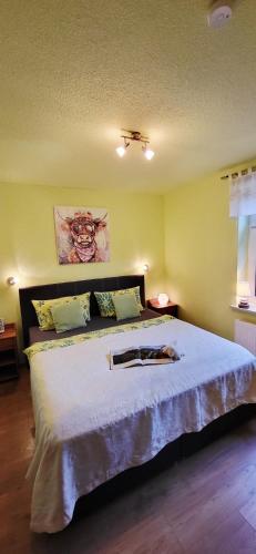 a bedroom with a large white bed in a room at Ferienhaus Rumpelt in Kurort Gohrisch