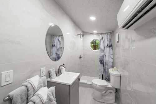 a white bathroom with a sink and a toilet at Hickory Hideaway Dollywood, Island, LeConte in Pigeon Forge