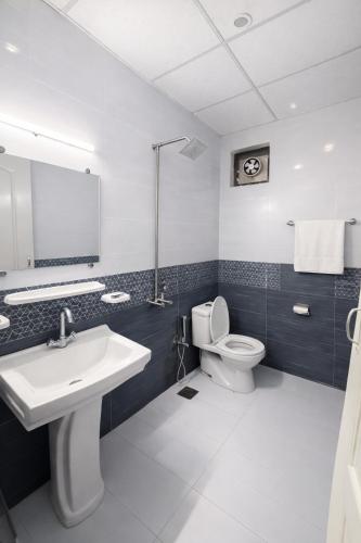 a bathroom with a sink and a toilet at Hotel Noor Sky in Islamabad
