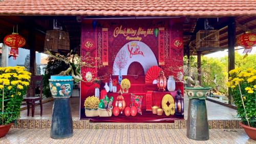 a display in a building with flowers and candles at ML Homestay in Binh Chau