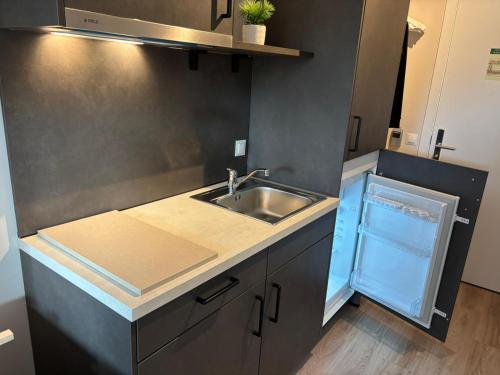 a kitchen with a sink and a counter top at Living Experience Granada in Granada