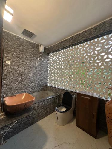 a bathroom with a sink and a toilet at Moksha farms -3bhk private villa with pool and nature in Pālghar