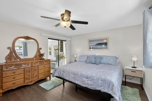 a bedroom with a bed and a dresser and a mirror at Bright Furnished Home in Coastal in Englewood