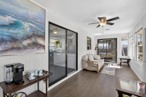 a living room with a couch and a ceiling fan at Bright Furnished Home in Coastal in Englewood