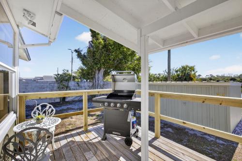 a barbecue on the deck of a house at Bright Furnished Home in Coastal in Englewood