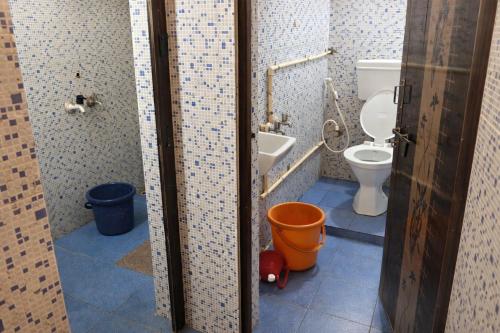 a bathroom with a toilet and a bidet at Manan Beach Resort in Malpe