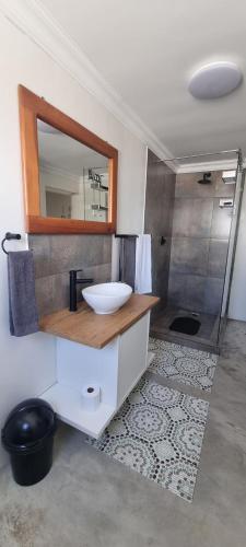 a bathroom with a sink and a mirror at MaKarLi Blu in St. Helena Bay