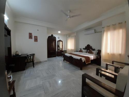 a bedroom with a bed and a desk in it at Hotel Aravali Hills View in Kuchāman City