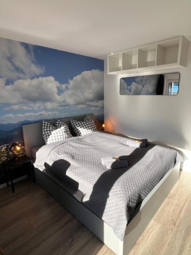 a bedroom with a large bed with a blue wall at Exklusive FeWo AllgäuStern Steibis mit WLAN Sauna Kamin und Oberstaufen PLUS Card mit SKIPASS in Oberstaufen