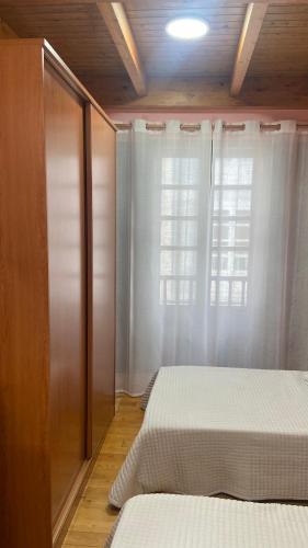 a bedroom with two beds and a window at Nido 33 in Ribadeo