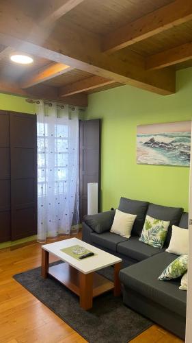 a living room with a couch and a coffee table at Nido 33 in Ribadeo