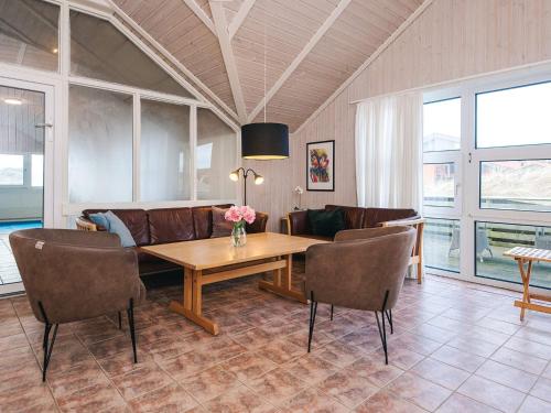 a living room with a table and a couch at 5 star holiday home in Ringkøbing in Ringkøbing