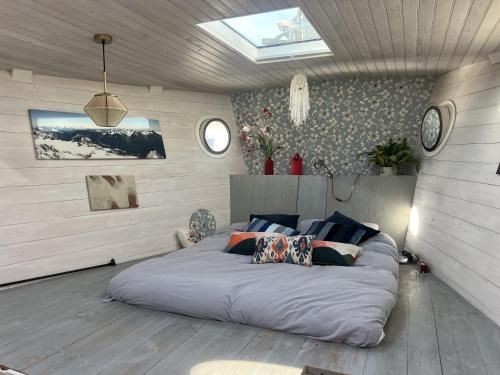 a bedroom with a large bed in a room at Stunning boat with a view in Amsterdam