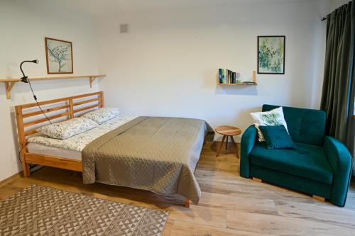 a bedroom with a bed and a couch and a chair at Grape House Kintai in Kintai