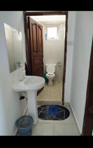 a bathroom with a sink and a toilet at Vescon 1 in Mombasa