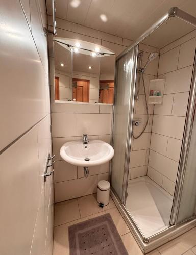 a bathroom with a sink and a shower at Ferienhaus Niederbichler in Gnesau