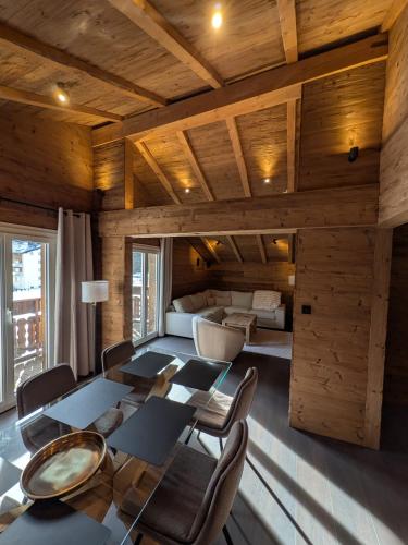 a room with a table and chairs and a bedroom at Nevita in Saas-Grund