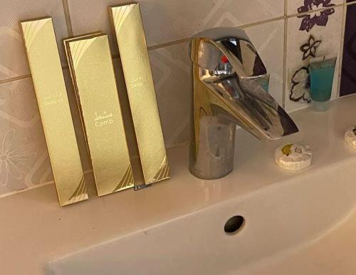 a sink with a faucet and two books on it at كيان الين- ابها in Abha
