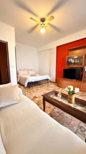 a living room with two beds and a ceiling fan at Appartamento "In viaggio come a casa" vicino alla Stazione, LTScalo! in Monticchio