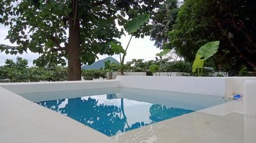 a swimming pool with a reflection in the water at Bamboo Payag Batangas in Laurel