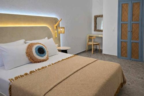 a bedroom with a large bed and a table at Papafotis Apartments & Suites in Alinda