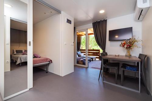 a room with a desk and a bed and a table at House no 3 in Pakoštane