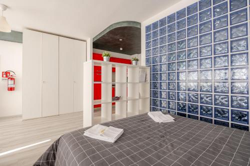 a room with a bed and a blue tiled wall at Fratelli Bandiera in Latina