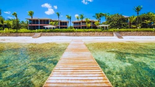 a wooden pathway over the water in front of a resort at Northern Lights #6 Condo in Old Man Bay